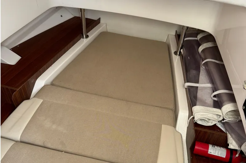 Slide: The Image of 2018 Pursuit S 328 Sport cabin interior with beige cushions and fire extinguisher. - 14