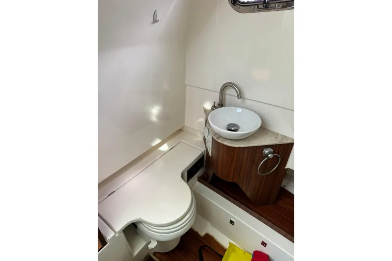 Slide: The Image of 2018 Pursuit S 328 Sport boat bathroom with modern sink and toilet. - 15