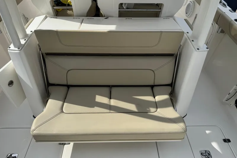 Slide: The Image of 2018 Pursuit S 328 Sport boat with beige cushioned seating. - 20