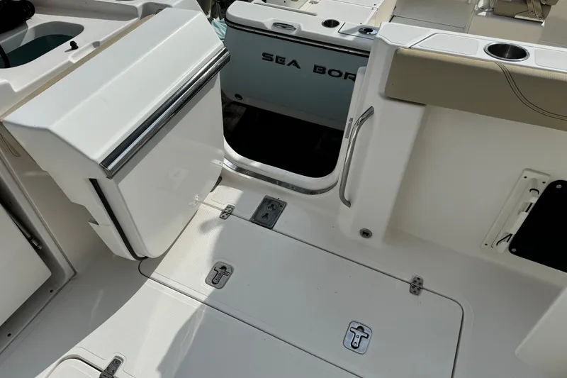 Slide: The Image of 2018 Pursuit S 328 Sport boat deck with storage compartments and seating area. - 21