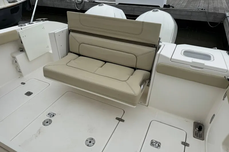 Slide: The Image of 2018 Pursuit S 328 Sport boat with beige seating and storage compartments. - 22