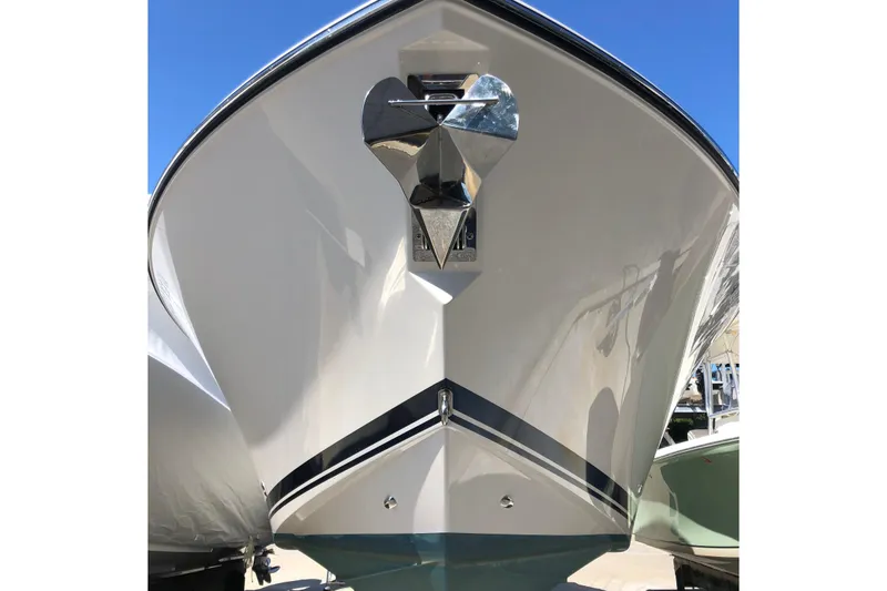 Slide: The Image of 2018 Pursuit S 328 Sport boat, front view with anchor, under clear blue sky. - 5