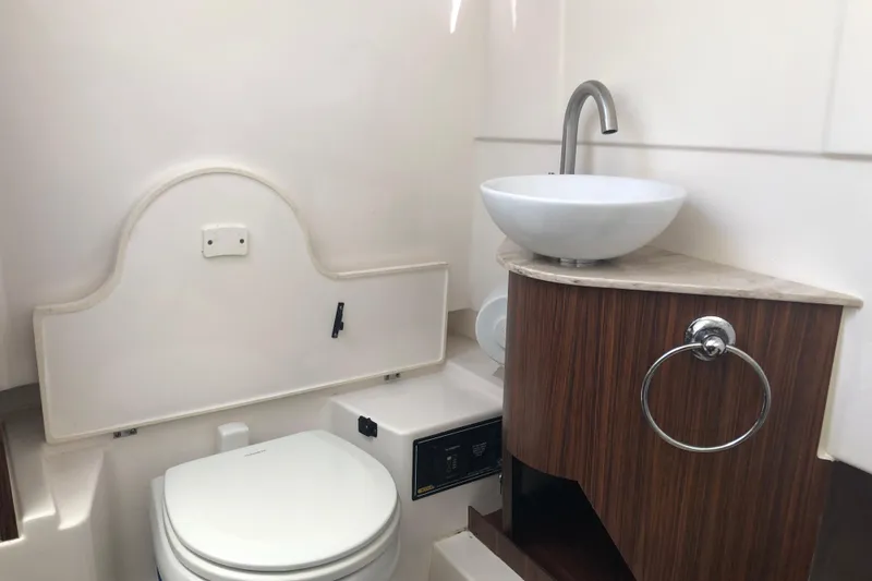 Slide: The Image of 2018 Pursuit S 328 Sport boat bathroom with modern sink and toilet. - 7