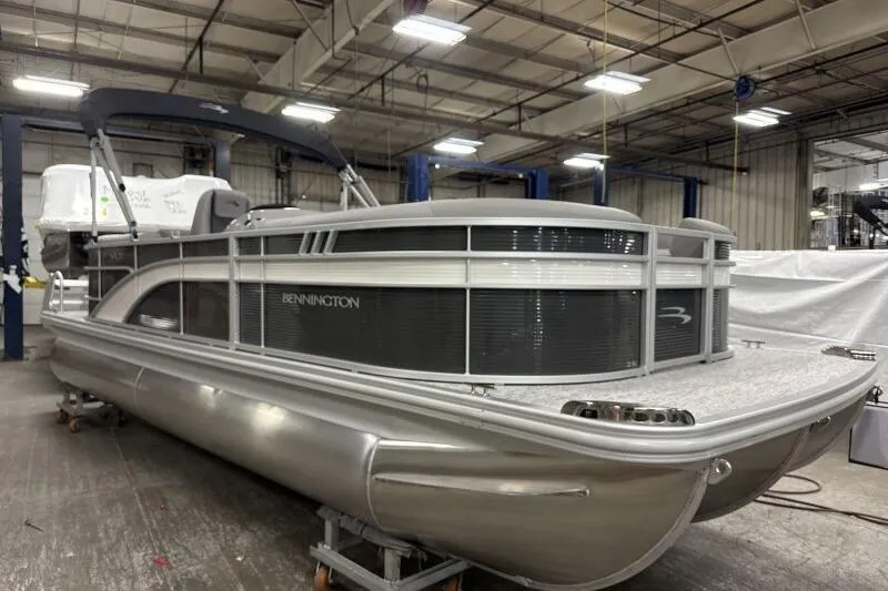The Image of 2026 Bennington 22SXSR pontoon boat in a warehouse setting. - 1