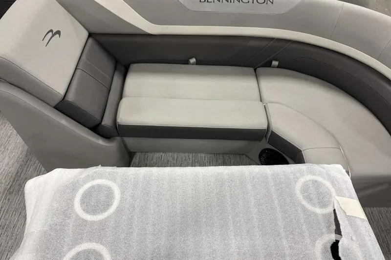 Slide: The Image of 2026 Bennington 22SXSR boat interior with gray seating and protective cover. - 12