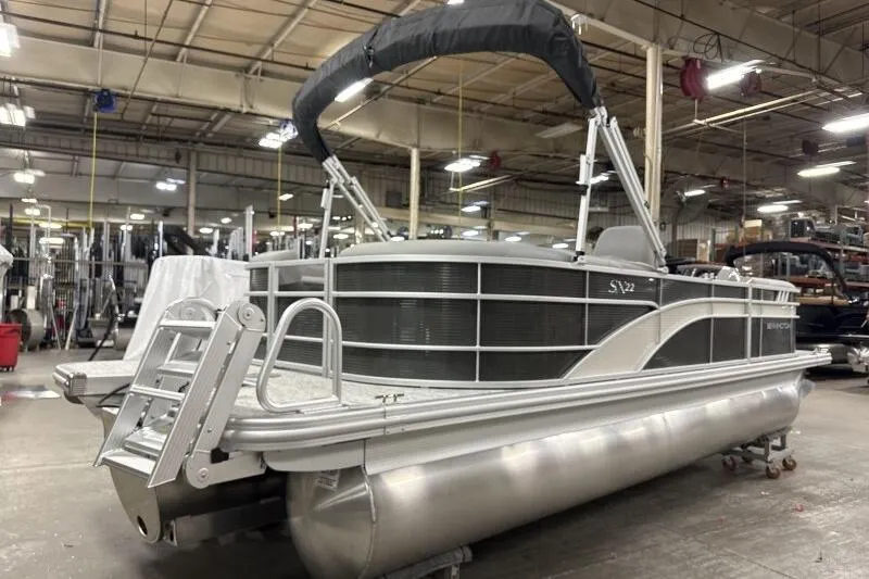 Slide: The Image of 2026 Bennington 22SXSR pontoon boat in a warehouse setting. - 5
