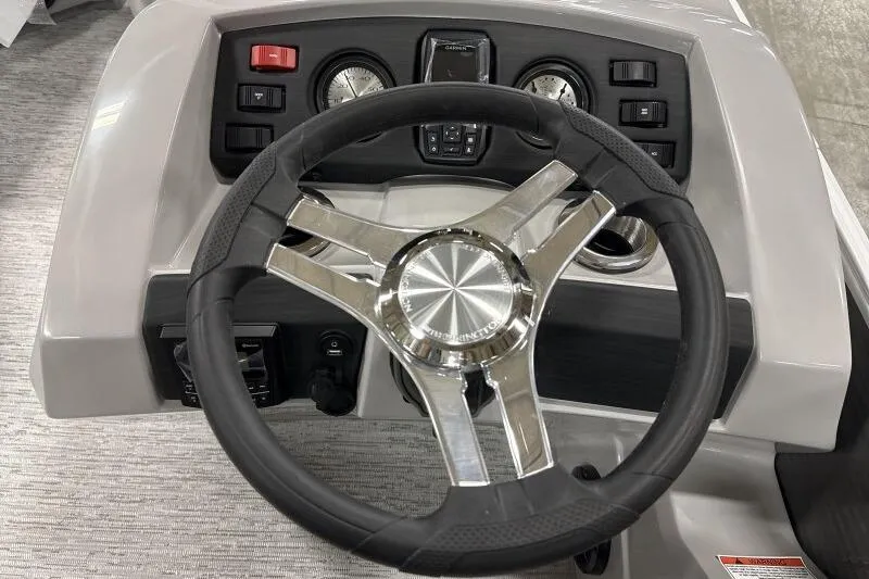Slide: The Image of Steering wheel and dashboard of 2026 Bennington 22SXSR boat, featuring modern controls. - 9
