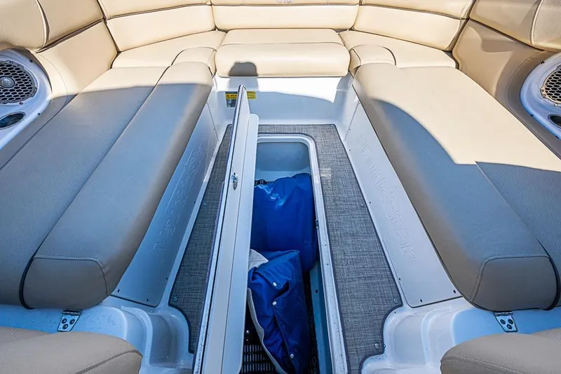Slide: The Image of 2019 NauticStar 243DC Sport Deck boat interior with open storage compartment. - 10