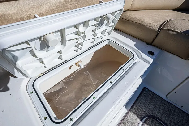 Slide: The Image of Open storage compartment on 2019 NauticStar 243DC Sport Deck boat interior. - 13