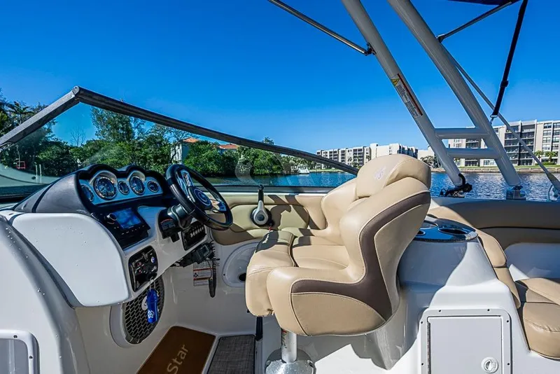 Slide: The Image of 2019 NauticStar 243DC Sport Deck boat interior with steering console and comfortable seating. - 18