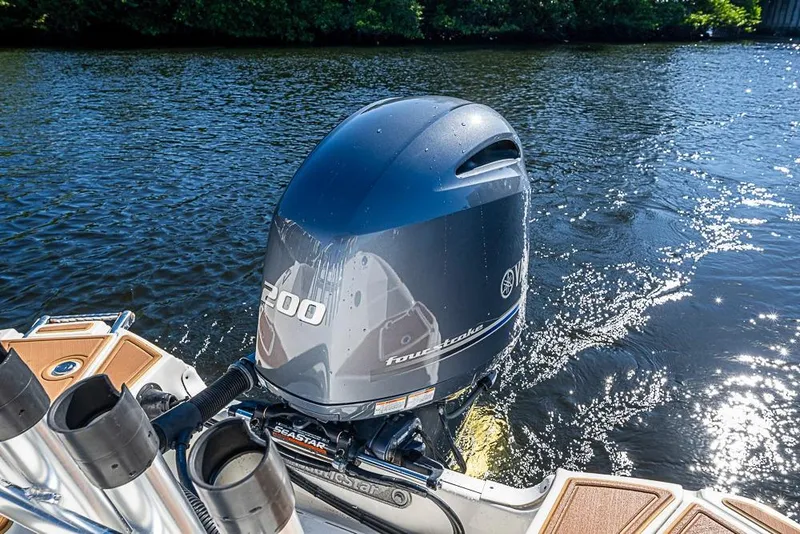 Slide: The Image of 2019 NauticStar 243DC Sport Deck with Yamaha 200 outboard engine on water. - 2