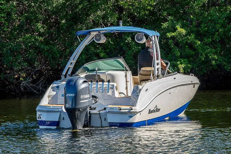 Slide: The Image of 2019 NauticStar 243DC Sport Deck boat cruising on a calm lake. - 36