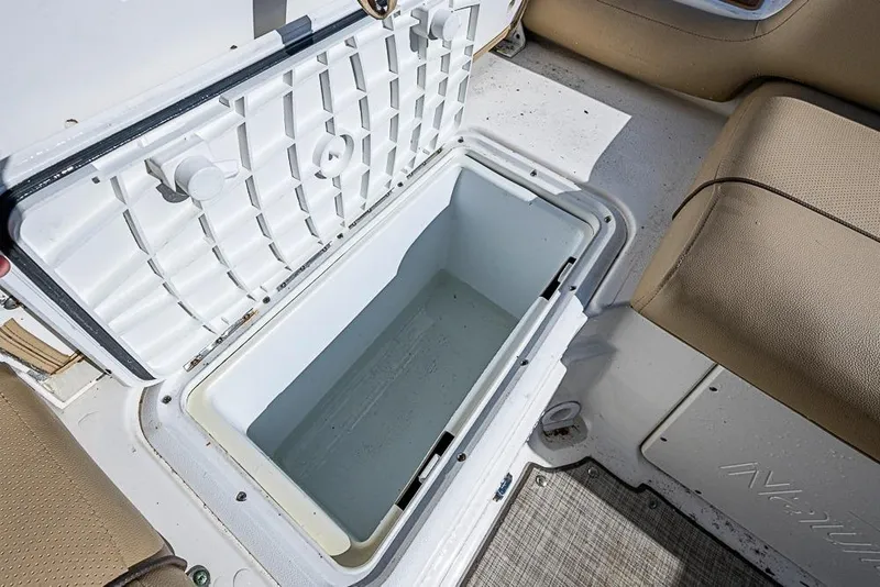 Slide: The Image of 2019 NauticStar 243DC Sport Deck boat with open storage compartment. - 5