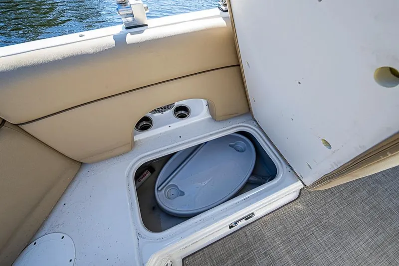Slide: The Image of Storage compartment on 2019 NauticStar 243DC Sport Deck boat, open with lid visible. - 6