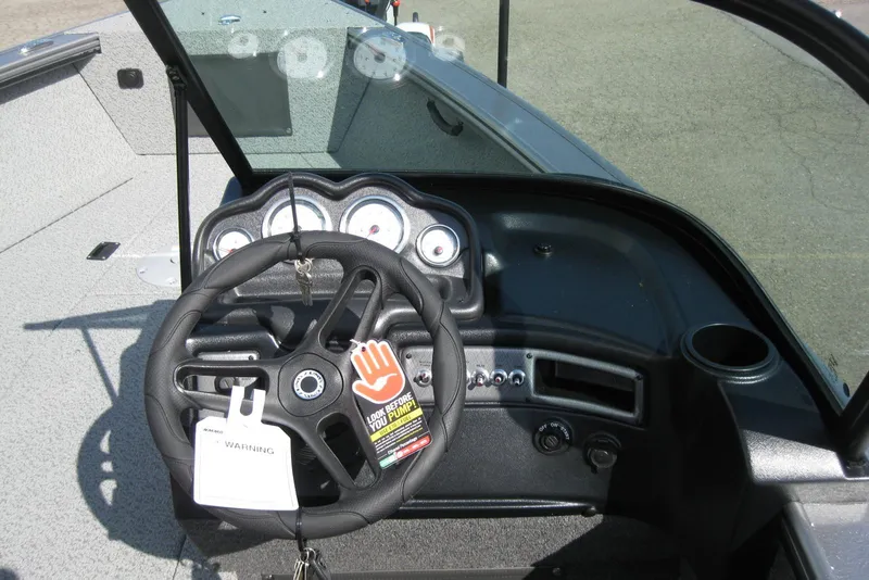 Slide: The Image of 2026 Lund 2075 Fisherman boat dashboard with steering wheel and instrument panel. - 15