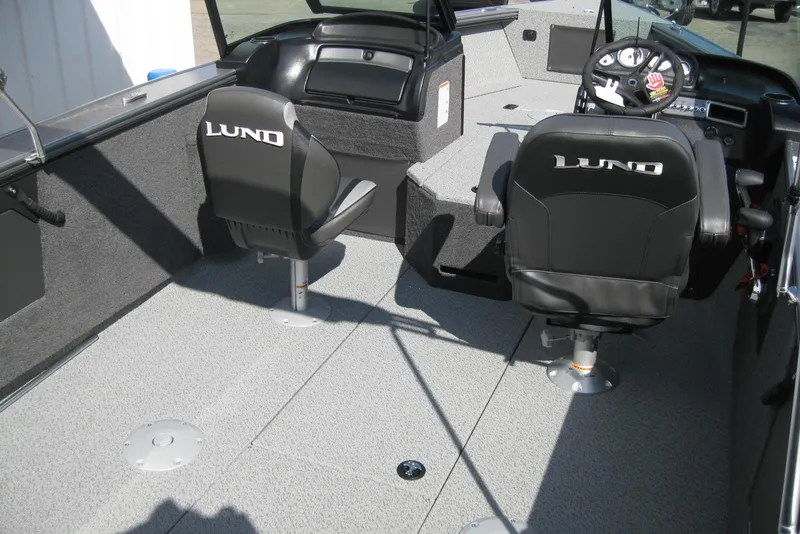 Slide: The Image of 2026 Lund 2075 Fisherman boat interior with two branded seats and steering console. - 7