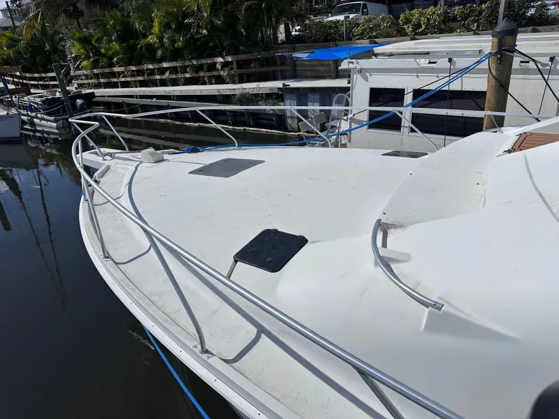 Slide: The Image of 1995 Mainship 40 Sport Sedan on water, front deck view. - 3
