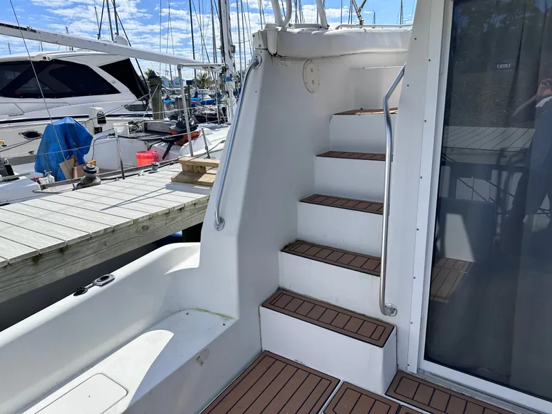 Slide: The Image of Interior of a 1995 Mainship 40 Sport Sedan with white seating. - 9