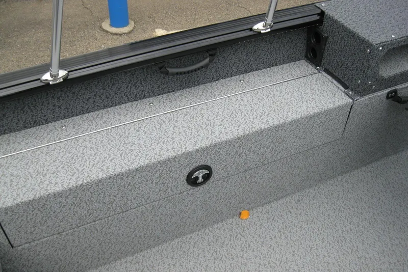 Slide: The Image of 2025 Lund 1875 Impact XS Sport boat interior with textured gray flooring and seating. - 10