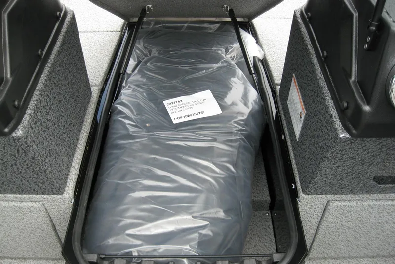 Slide: The Image of 2025 Lund 1875 Impact XS Sport boat storage compartment with packaged cover. - 14