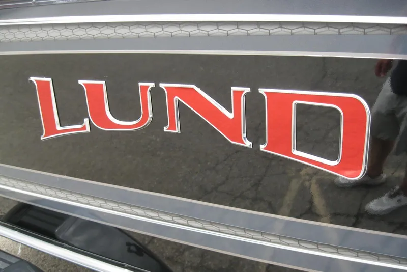 Slide: The Image of 2025 Lund 1875 Impact XS Sport logo on boat exterior. - 4