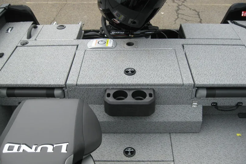 Slide: The Image of 2025 Lund 1875 Impact XS Sport boat interior with storage compartments and seating. - 8