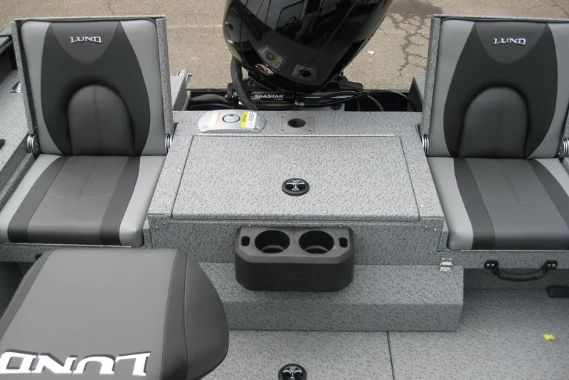 Slide: The Image of 2025 Lund 1875 Impact XS Sport boat interior with gray seating and cup holders. - 9
