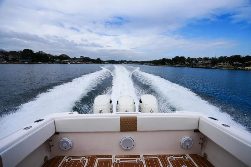 Slide: The Image of 1999 Intrepid 366 boat cruising on a lake, leaving a wake behind. - 12