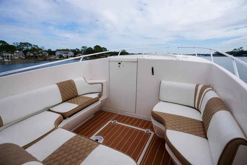 Slide: The Image of 1999 Intrepid 366 boat interior with cushioned seating and scenic water view. - 15
