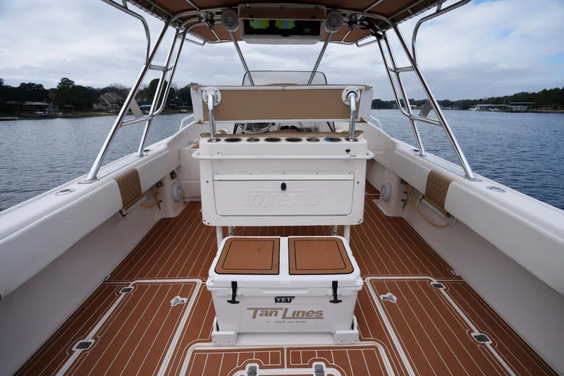 Slide: The Image of 1999 Intrepid 366 boat interior with teak flooring and fishing rod holders. - 16