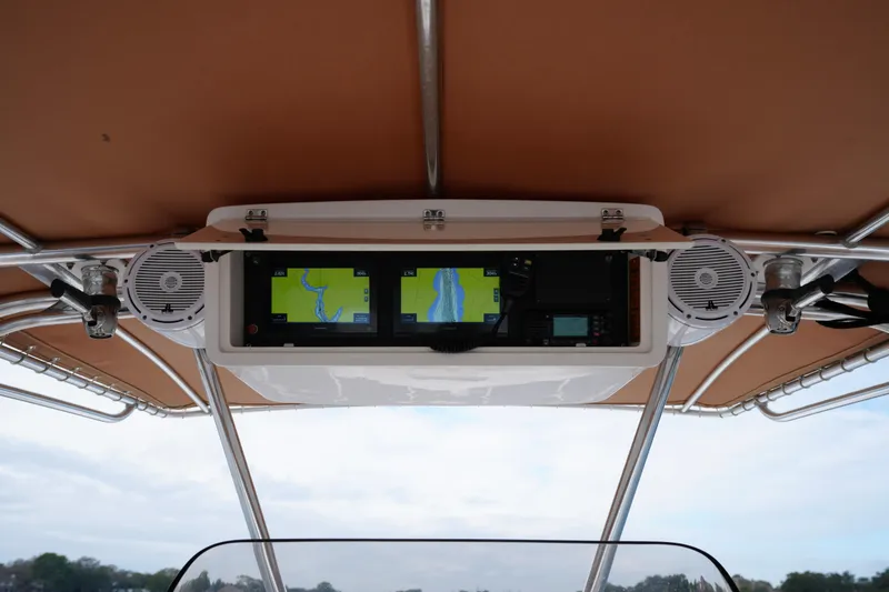 Slide: The Image of 1999 Intrepid 366 boat dashboard with navigation screens and speakers under canopy. - 18