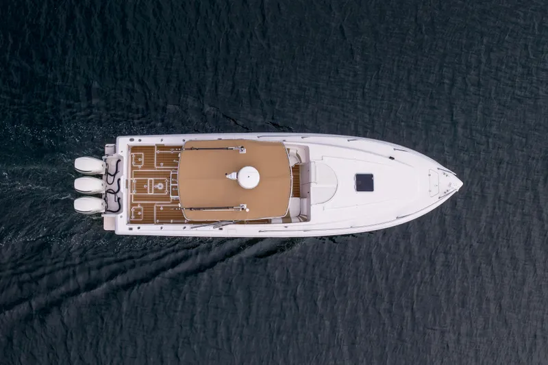 Slide: The Image of Overhead view of 1999 Intrepid 366 boat cruising on water. - 2