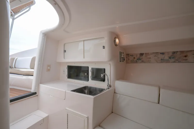 Slide: The Image of Interior of 1999 Intrepid 366 boat with sink, seating, and storage cabinets. - 23