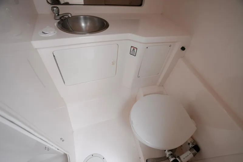 Slide: The Image of 1999 Intrepid 366 boat bathroom with sink and toilet. - 26