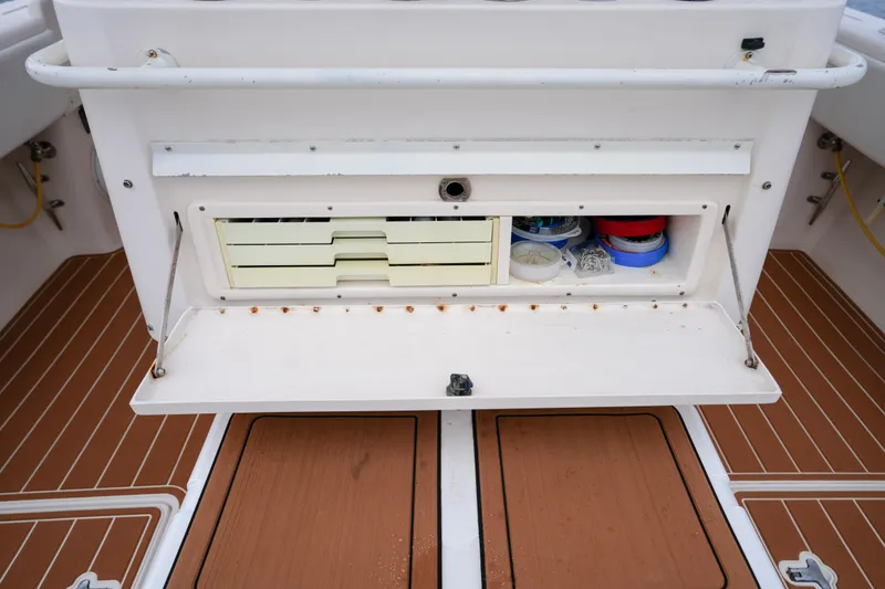 Slide: The Image of 1999 Intrepid 366 boat storage compartment with organized fishing gear and accessories. - 29