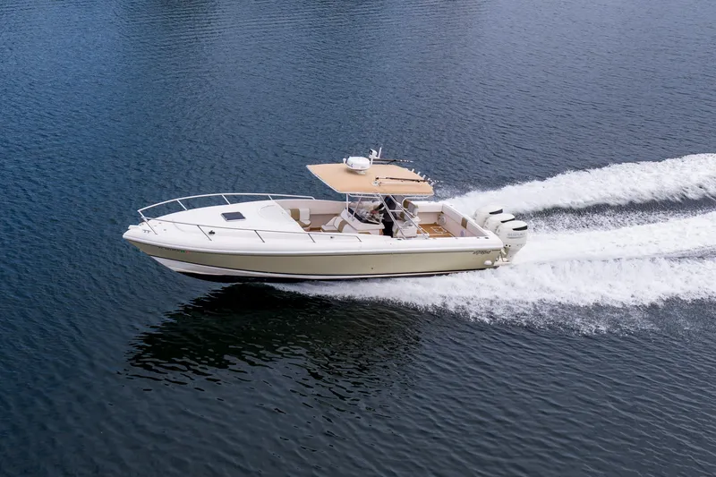 Slide: The Image of 1999 Intrepid 366 boat cruising on open water, showcasing sleek design and powerful engines. - 35