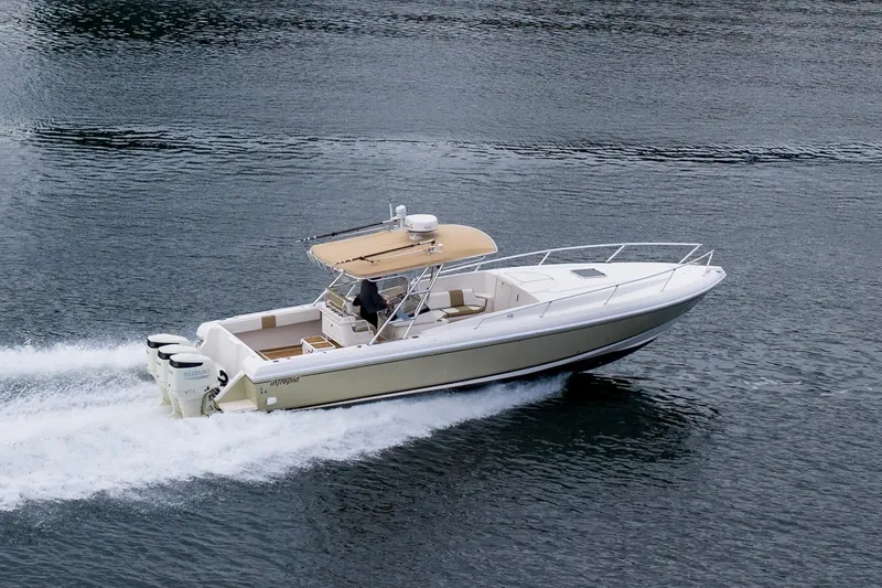 Slide: The Image of 1999 Intrepid 366 boat cruising on water with triple outboard engines. - 44