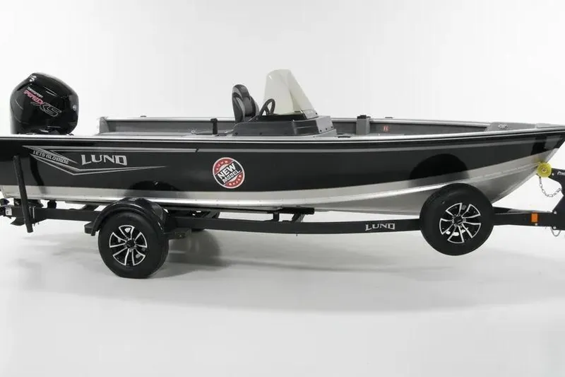 The Image of 2025 Lund 1800 Alaskan SS boat on trailer, black and silver design. - 1