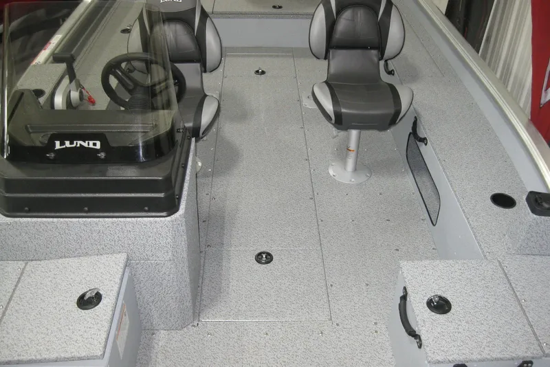 Slide: The Image of 2025 Lund 1800 Alaskan SS boat interior with seating and steering console. - 11