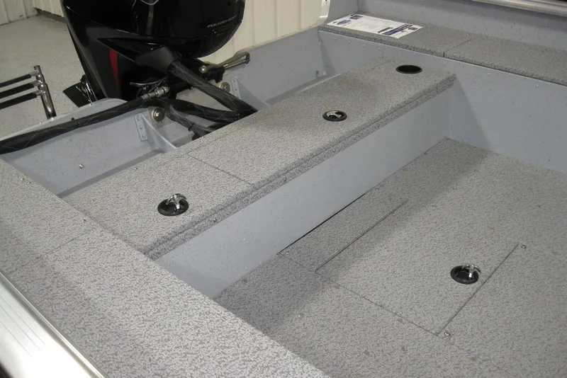 Slide: The Image of Interior of 2025 Lund 1800 Alaskan SS boat, featuring gray textured flooring and storage compartments. - 7