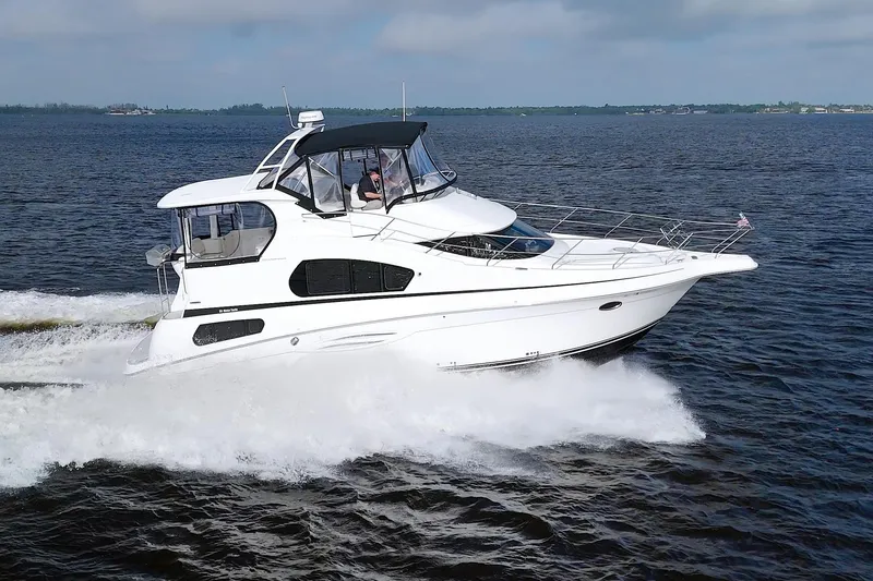 Slide: The Image of 2006 Silverton 39 Motor Yacht cruising on open water, showcasing sleek design and performance. - 11