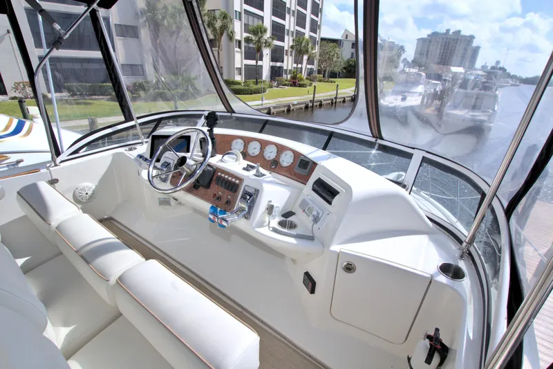 Slide: The Image of 2006 Silverton 39 Motor Yacht helm with modern controls and waterfront view. - 21