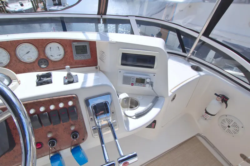 Slide: The Image of 2006 Silverton 39 Motor Yacht helm with controls, gauges, and navigation equipment. - 22