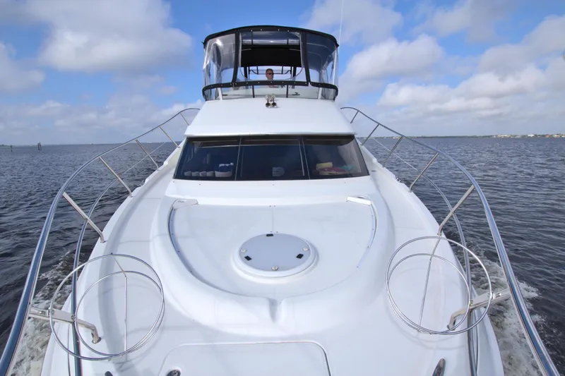 Slide: The Image of 2006 Silverton 39 Motor Yacht cruising on open water under a blue sky. - 31
