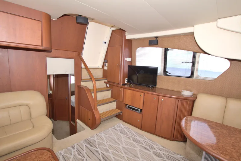 Slide: The Image of Interior of 2006 Silverton 39 Motor Yacht with elegant wood finishes and cozy seating area. - 39