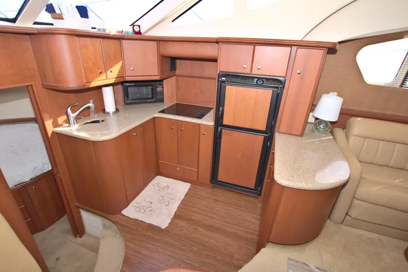 Slide: The Image of Interior of 2006 Silverton 39 Motor Yacht with kitchen and seating area. - 45