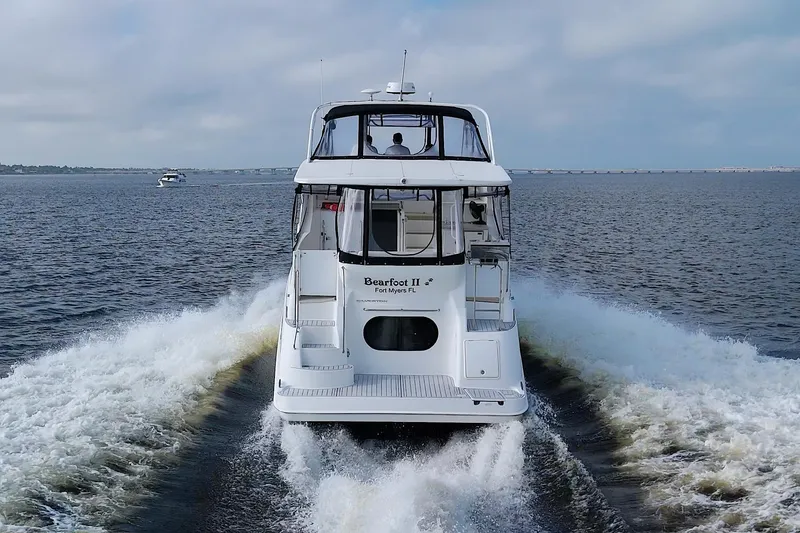 Slide: The Image of 2006 Silverton 39 Motor Yacht cruising on open water, rear view. - 6
