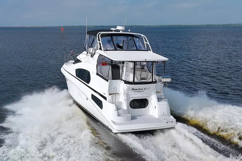 Slide: The Image of 2006 Silverton 39 Motor Yacht cruising on open water, rear view. - 7