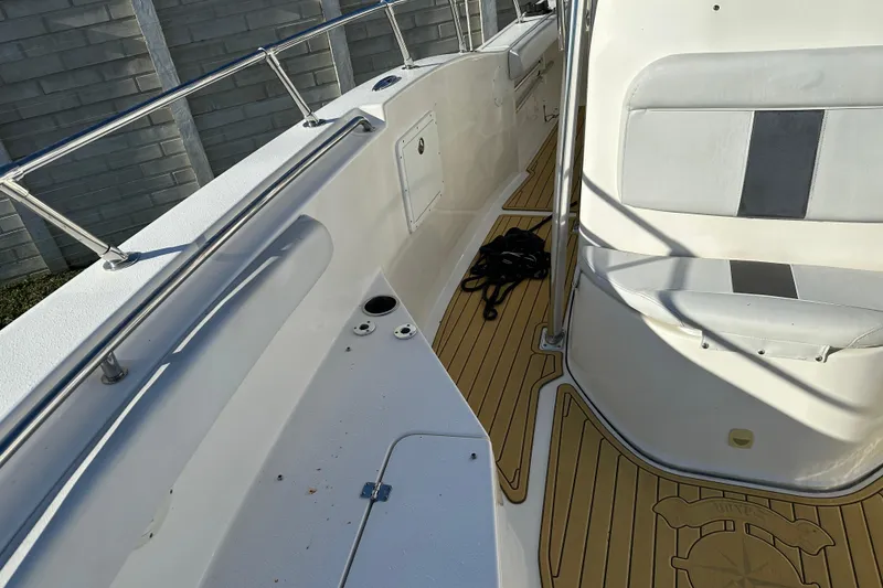 Slide: The Image of 2014 Tidewater 250 CC Adventure boat interior with seating and deck details. - 10
