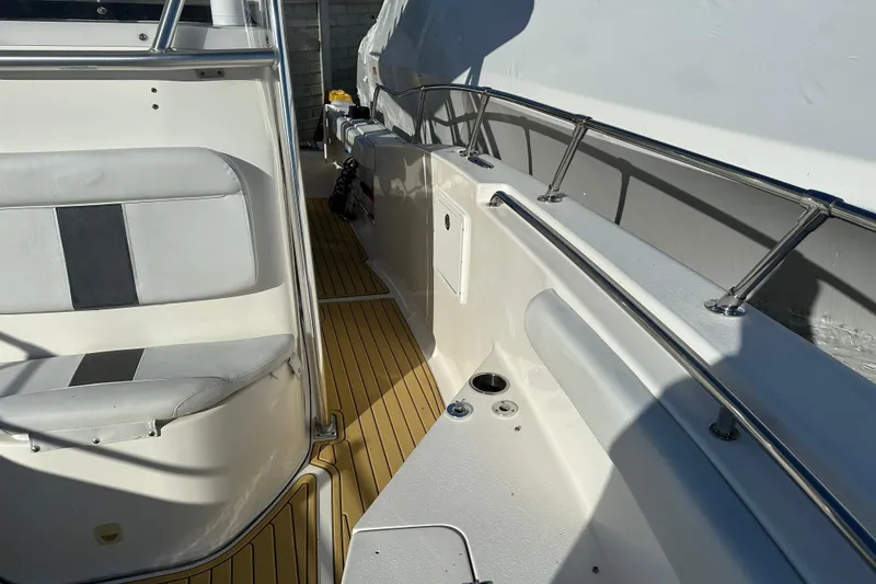 Slide: The Image of 2014 Tidewater 250 CC Adventure boat interior with seating and railings. - 11